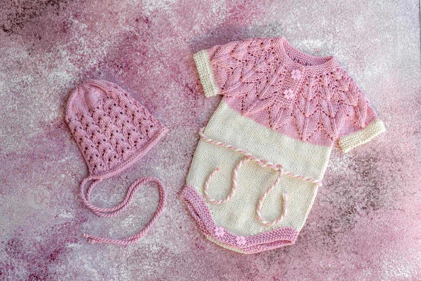 Knitted clothes made of natural wool threads for a newborn baby photo