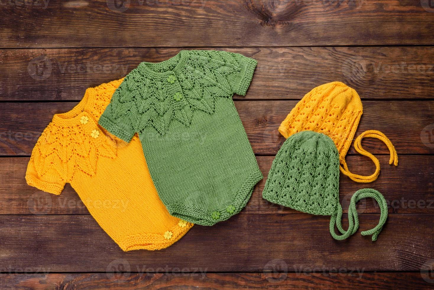 Knitted clothes made of natural wool threads for a newborn baby photo