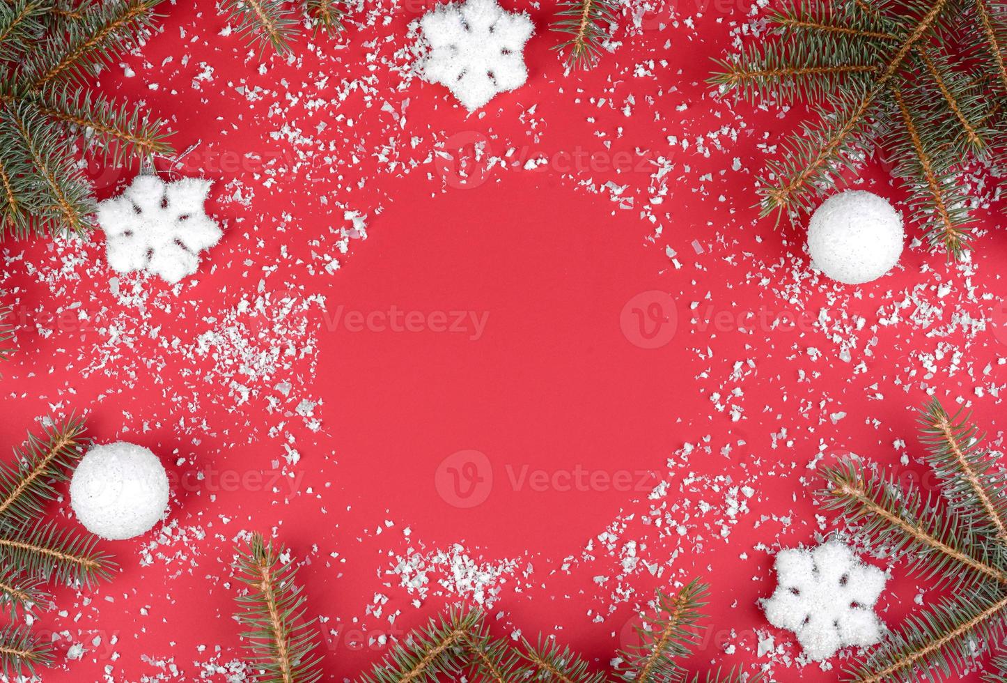 Christmas red decorations, fir tree branches on red background photo