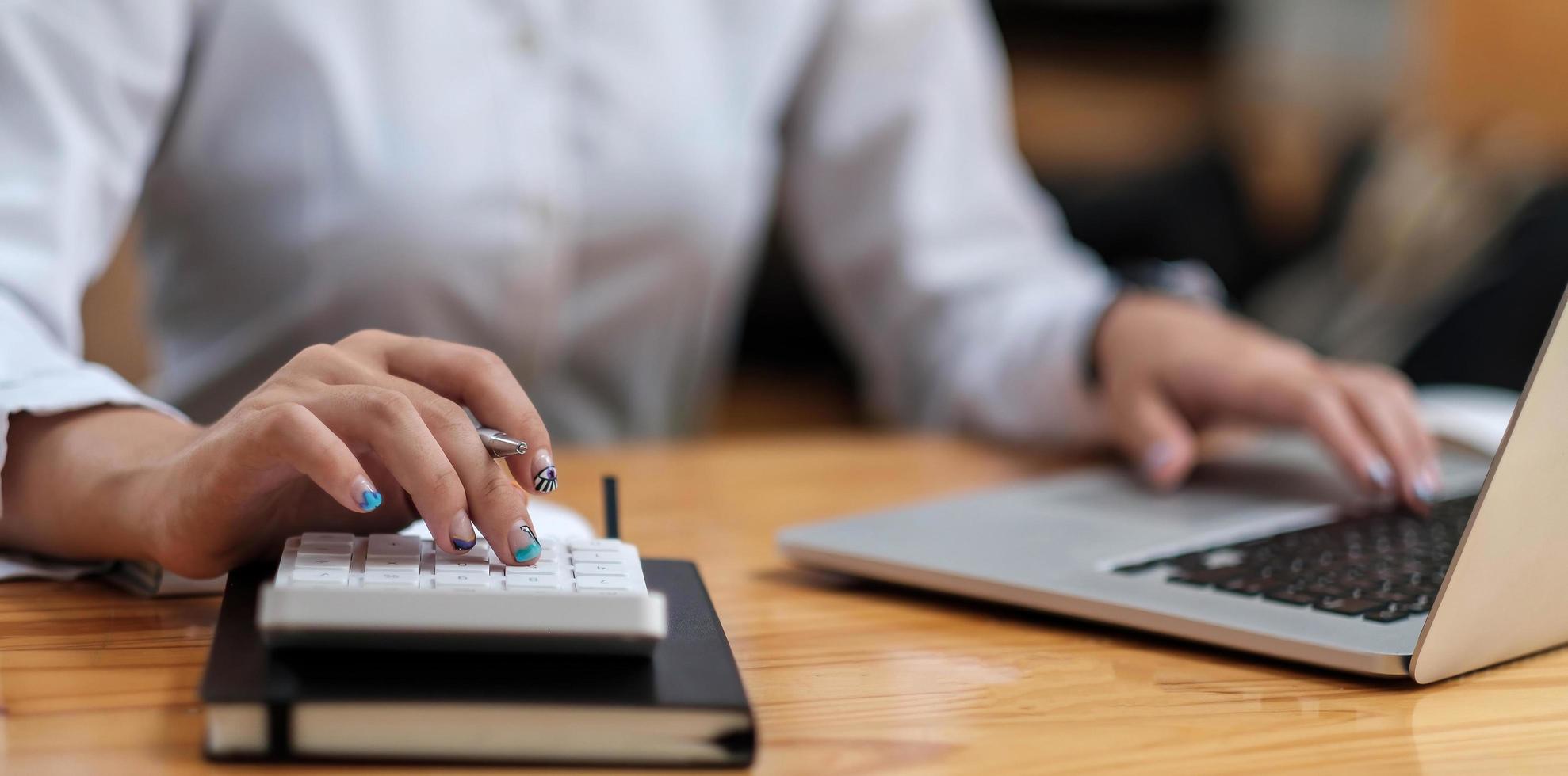 Businesswoman using calculator photo