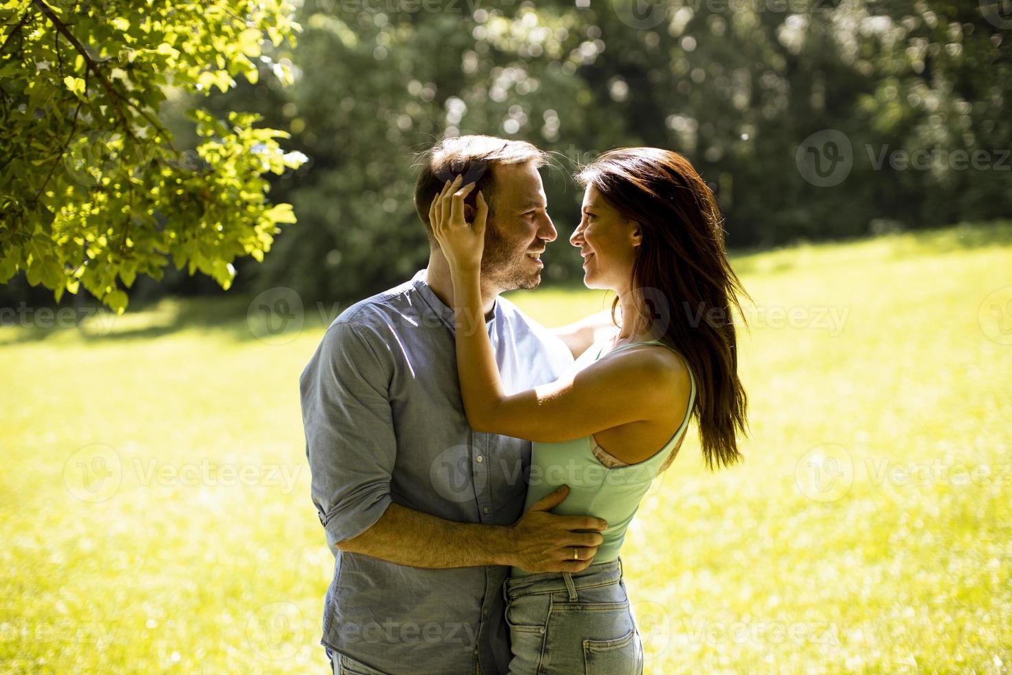 Affectionate young couple having fun on the green grass photo