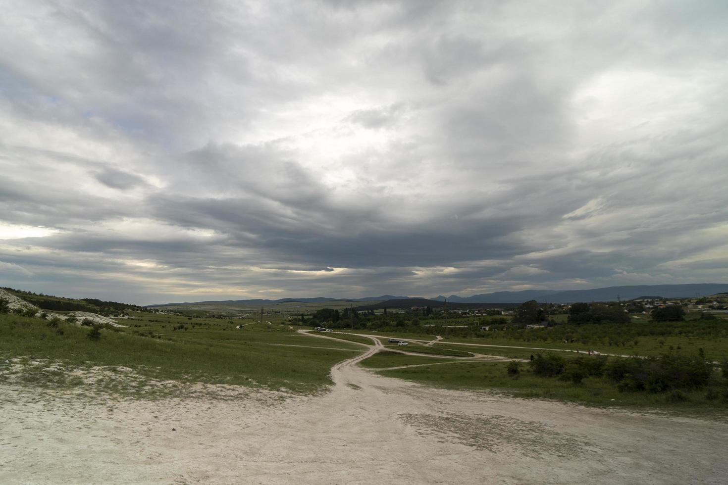 Landscape from a hill under a cloudy sky photo