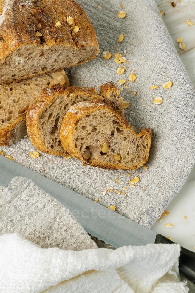 Delicious fresh baked bread on marble background. Healthy diet lifestyle. photo