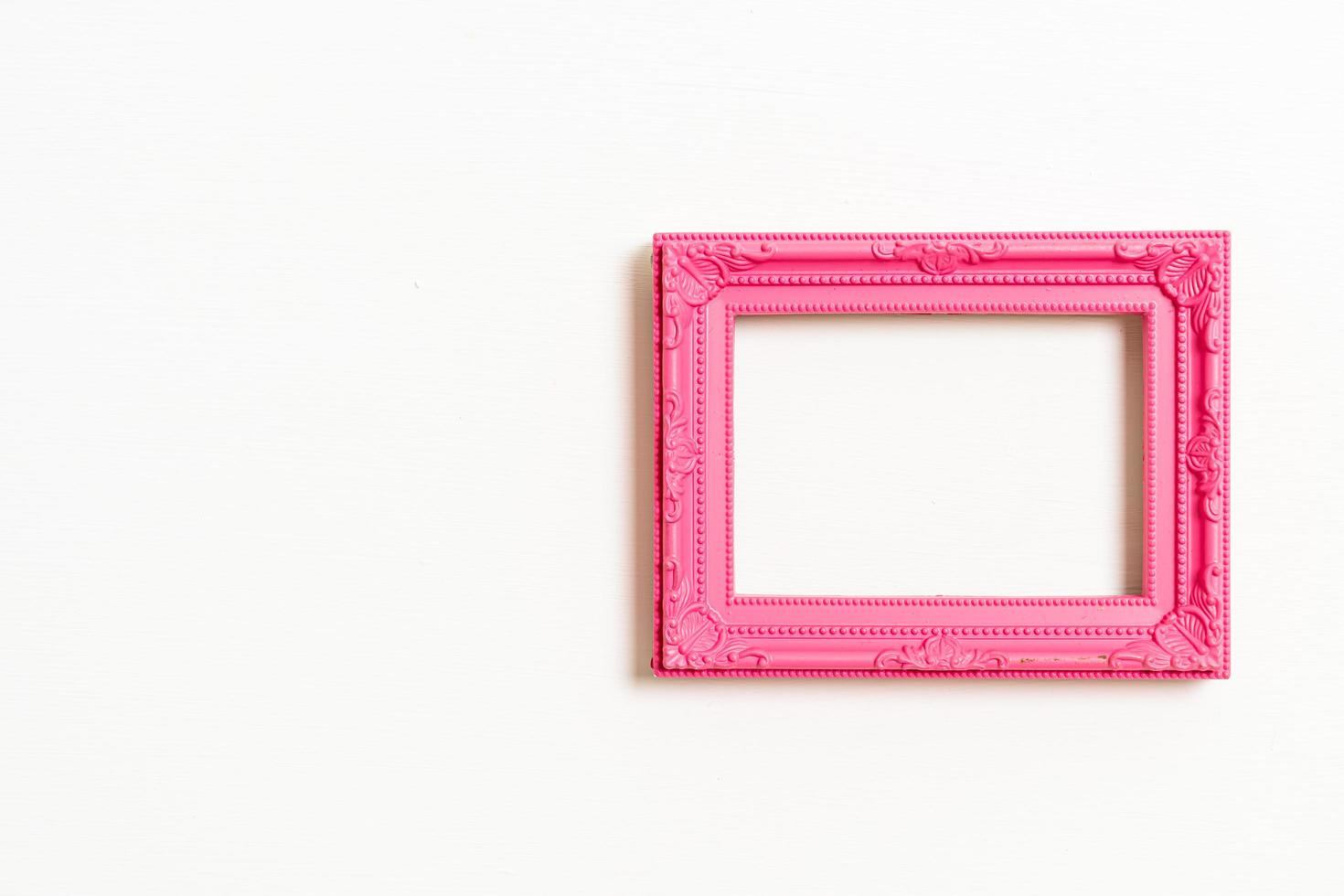 Empty picture frame on white wall background with copy space photo