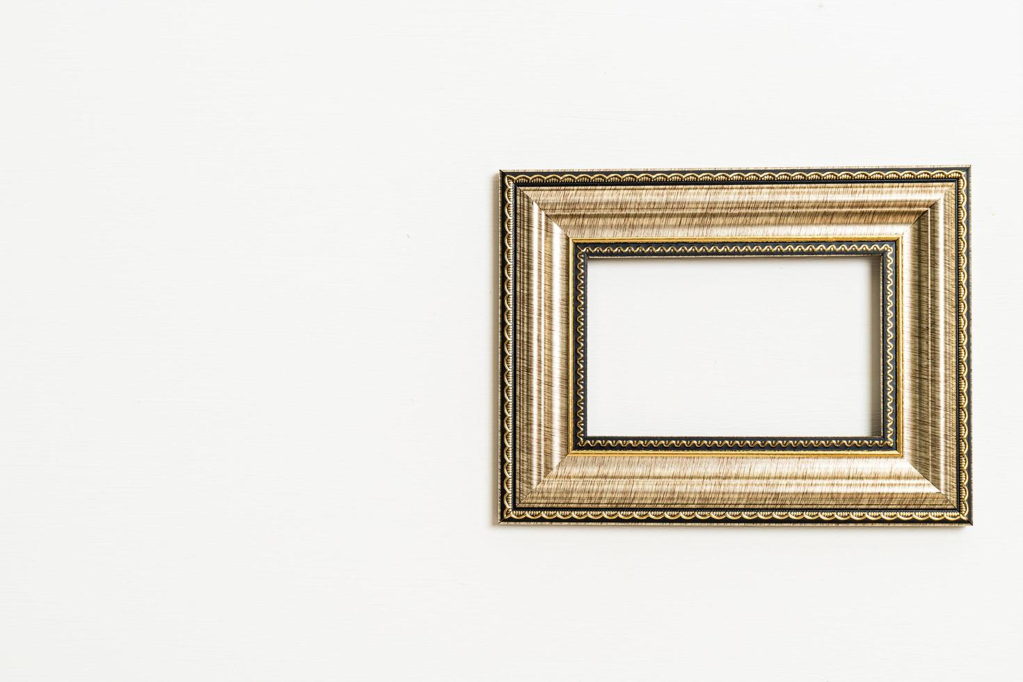 Empty picture frame on white wall background with copy space photo