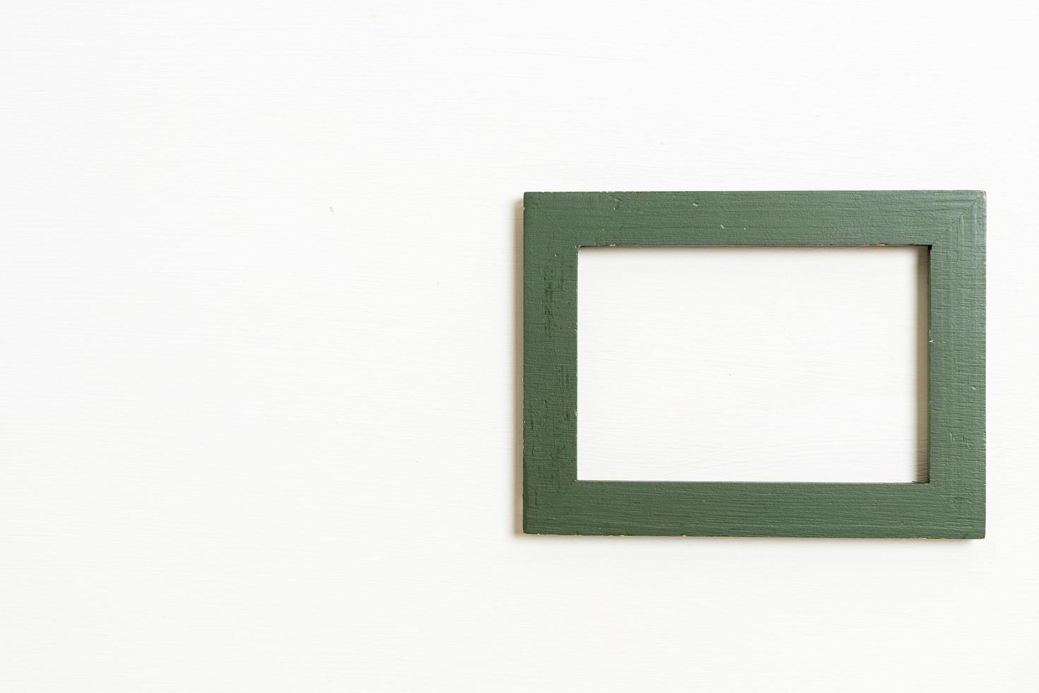 Empty picture frame on white wall background with copy space photo