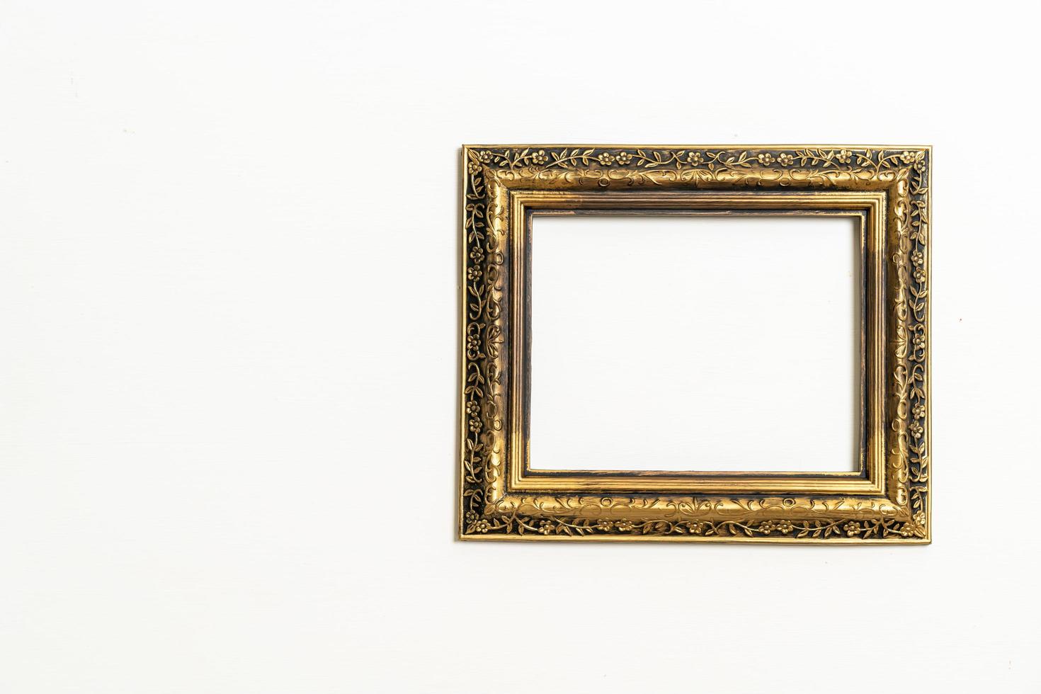 Empty picture frame on white wall background with copy space photo