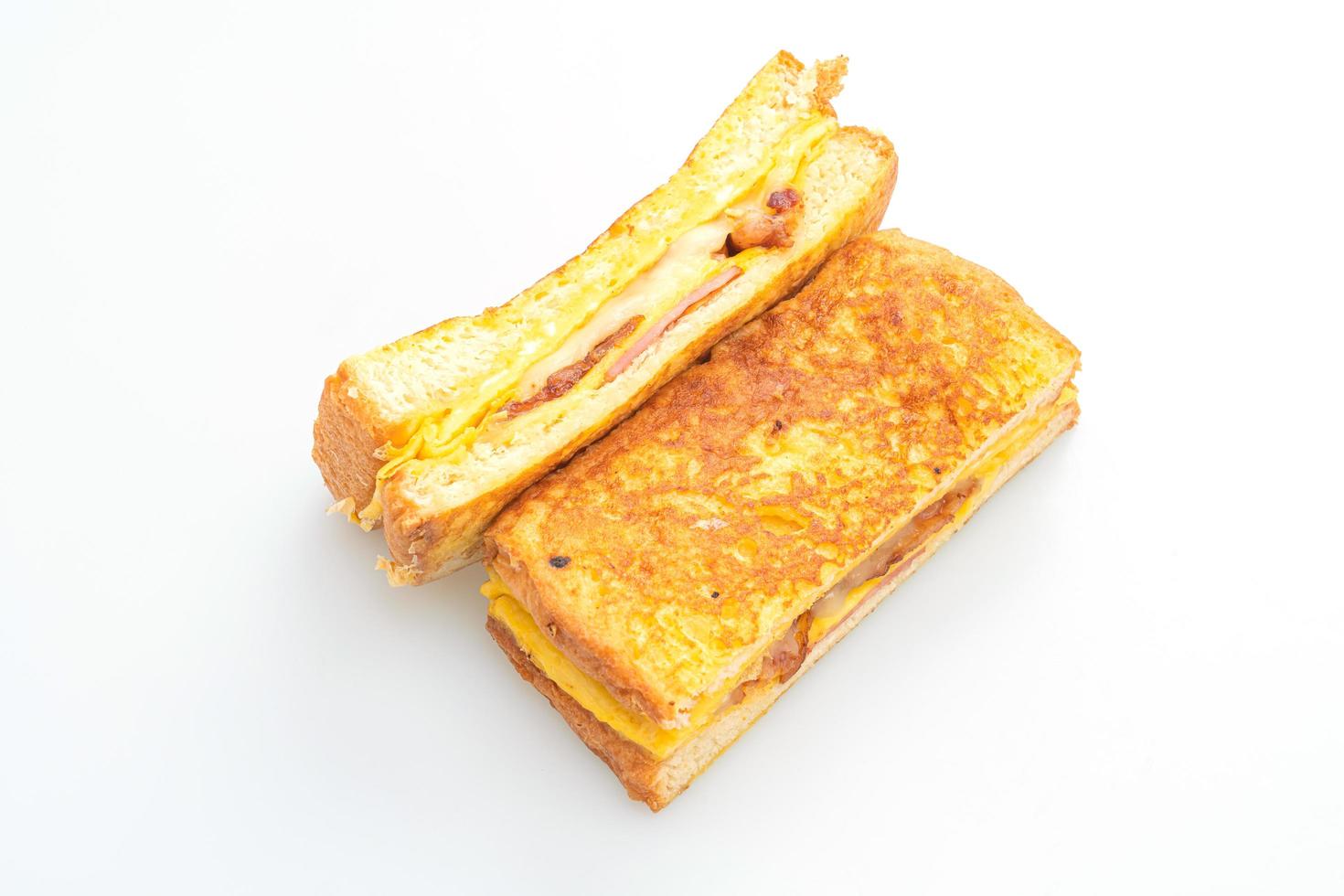 French toast ham, bacon, and cheese sandwich with egg isolated on white background photo