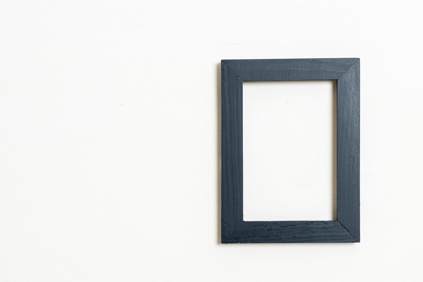 Empty picture frame on white wall background with copy space photo