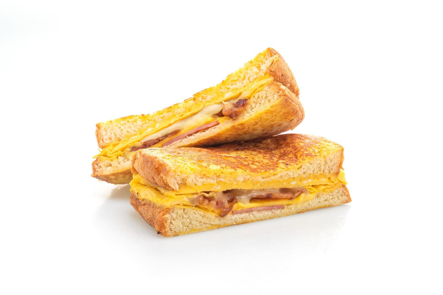 French toast ham, bacon, and cheese sandwich with egg isolated on white background photo