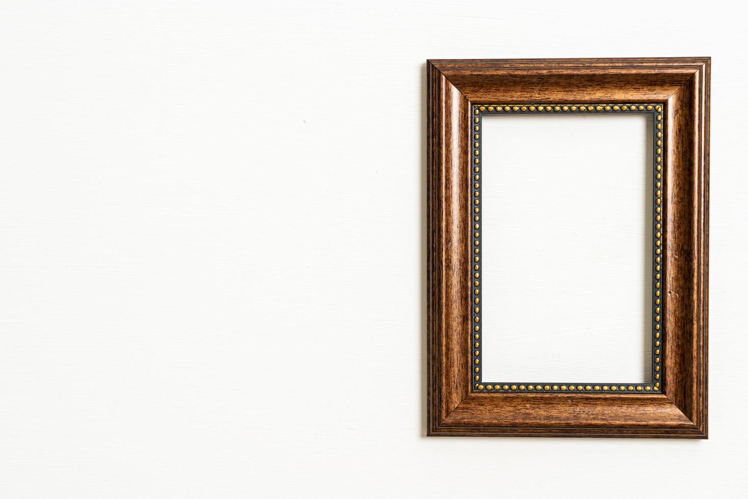 Empty picture frame on white wall background with copy space photo