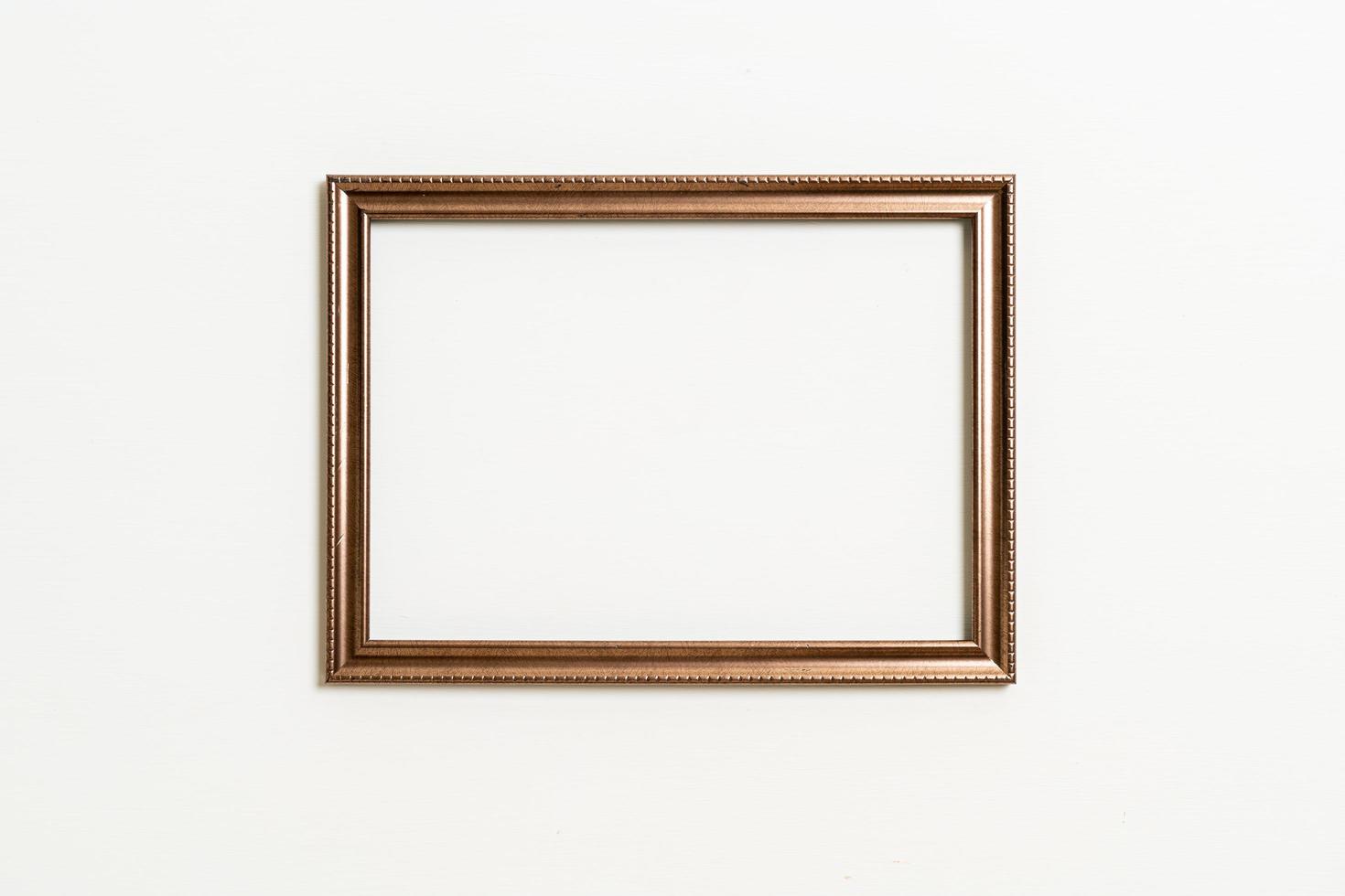 Empty picture frame on white wall background with copy space photo