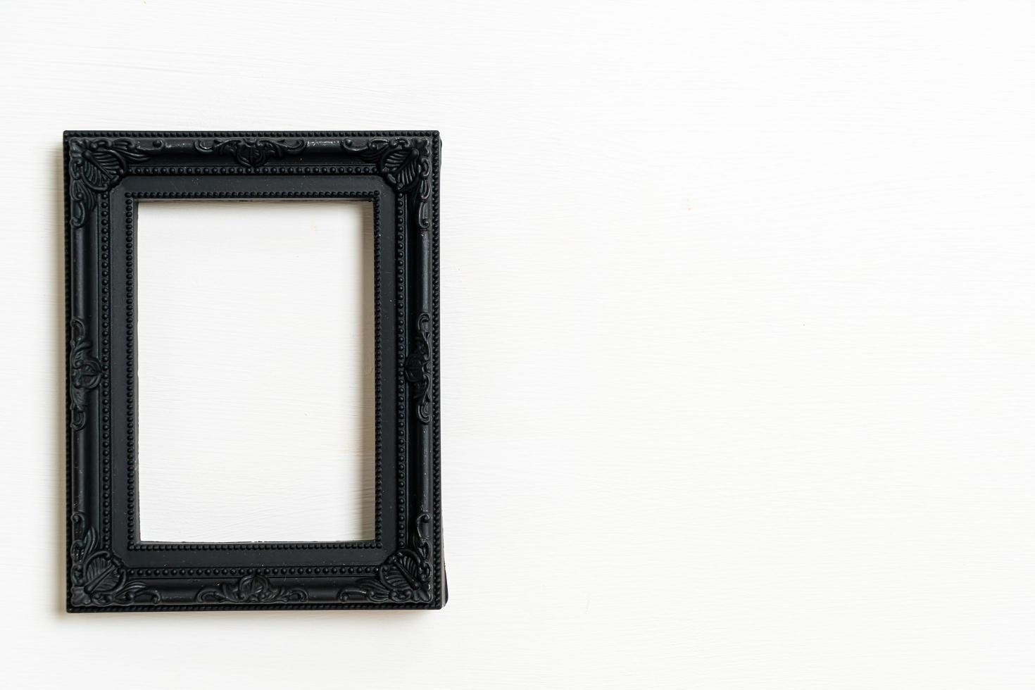 Empty picture frame on white wall background with copy space photo