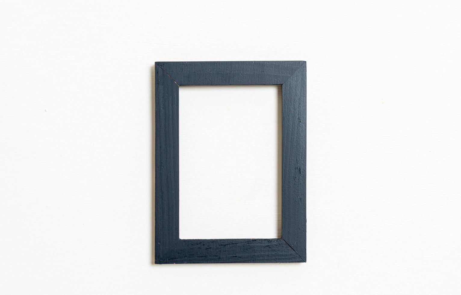 Empty picture frame on white wall background with copy space photo