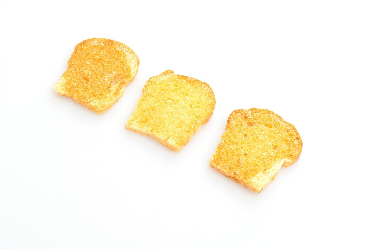 Baked crispy bread with butter and sugar isolated on white background photo