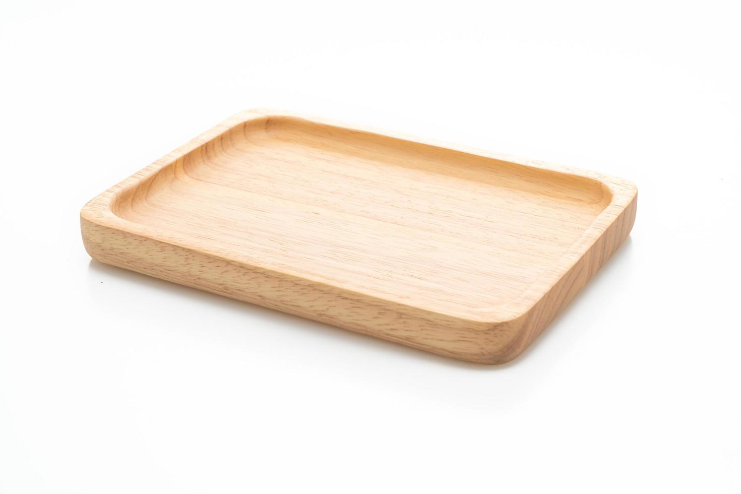 Wooden tray or plate isolated on white background photo