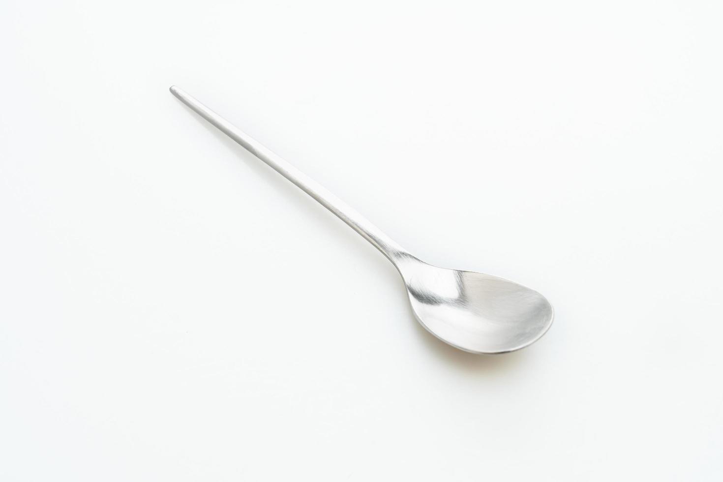 Silver spoon isolated on white background photo