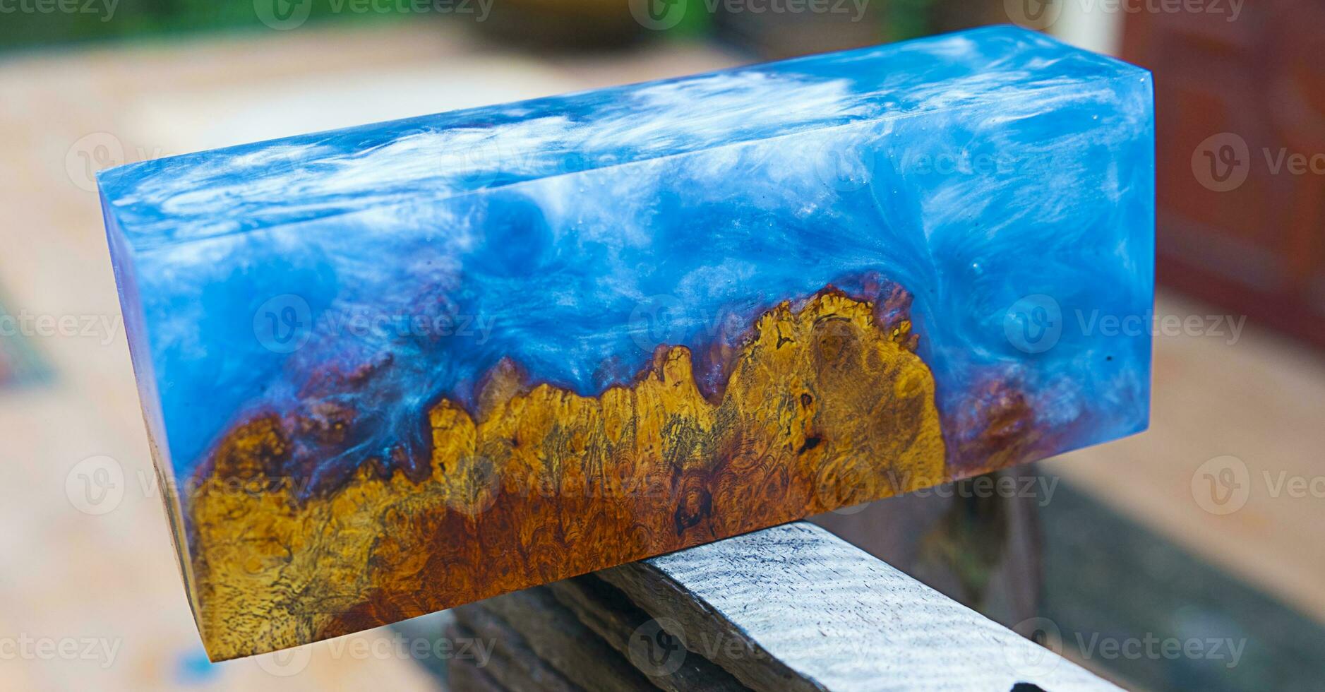 Casting epoxy resin maple burl wood on the table photo