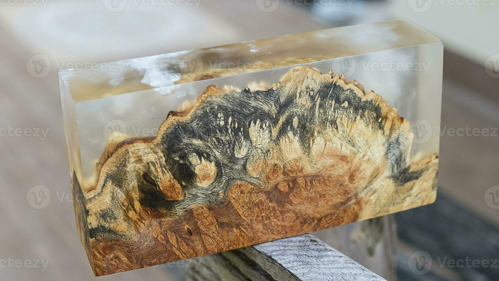 Casting epoxy resin maple burl wood on the table photo