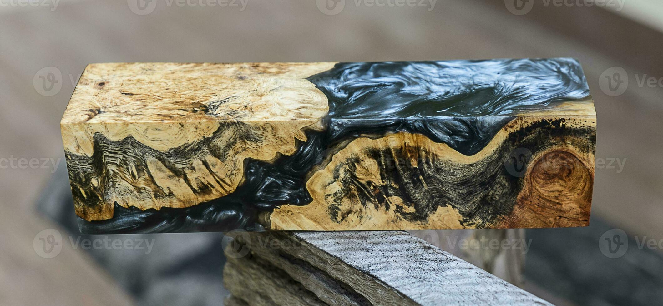 Casting epoxy resin maple burl wood on the table photo
