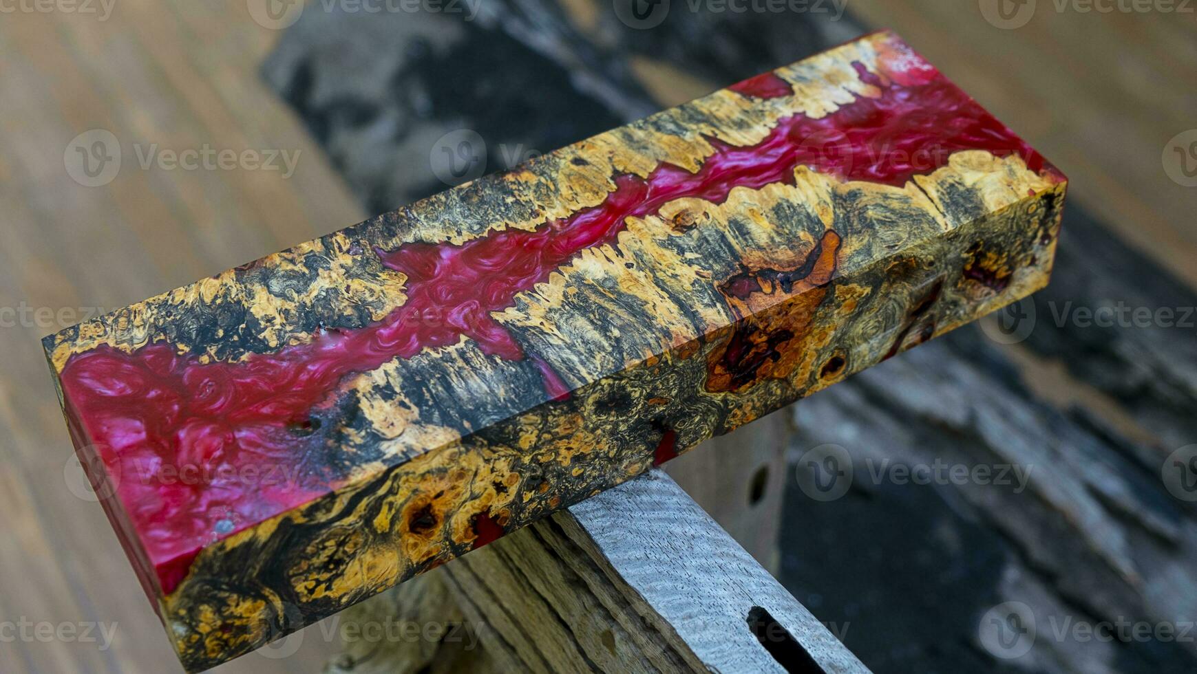 Casting epoxy resin maple burl wood on the table photo