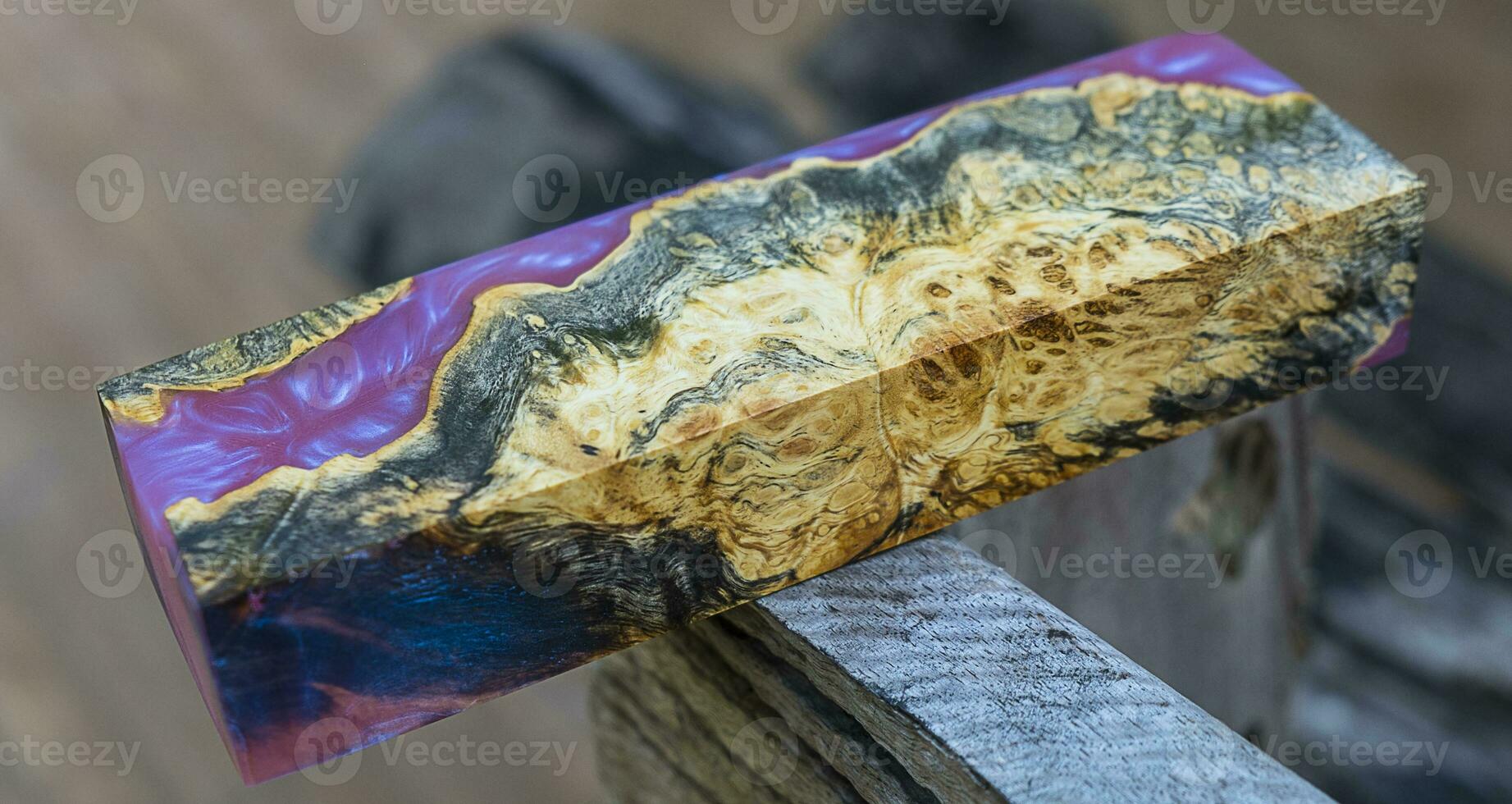 Casting epoxy resin maple burl wood on the table photo