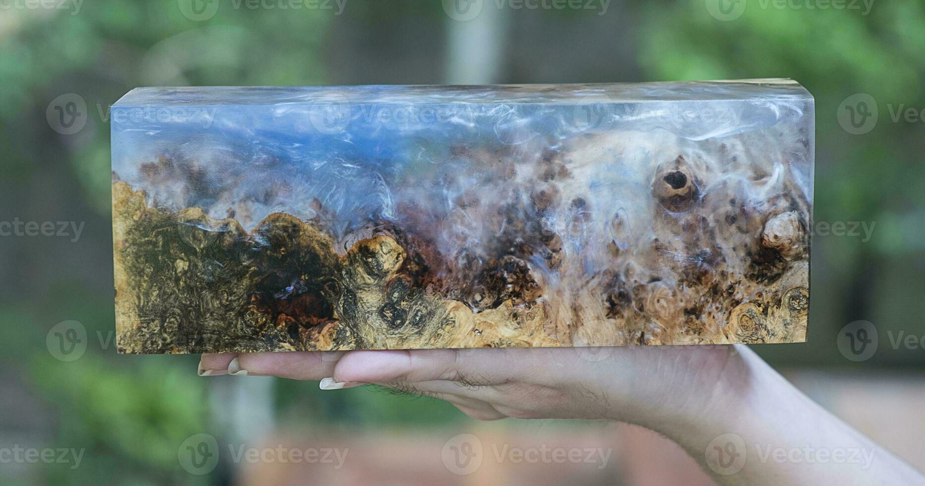 Casting epoxy resin maple burl wood on the table photo