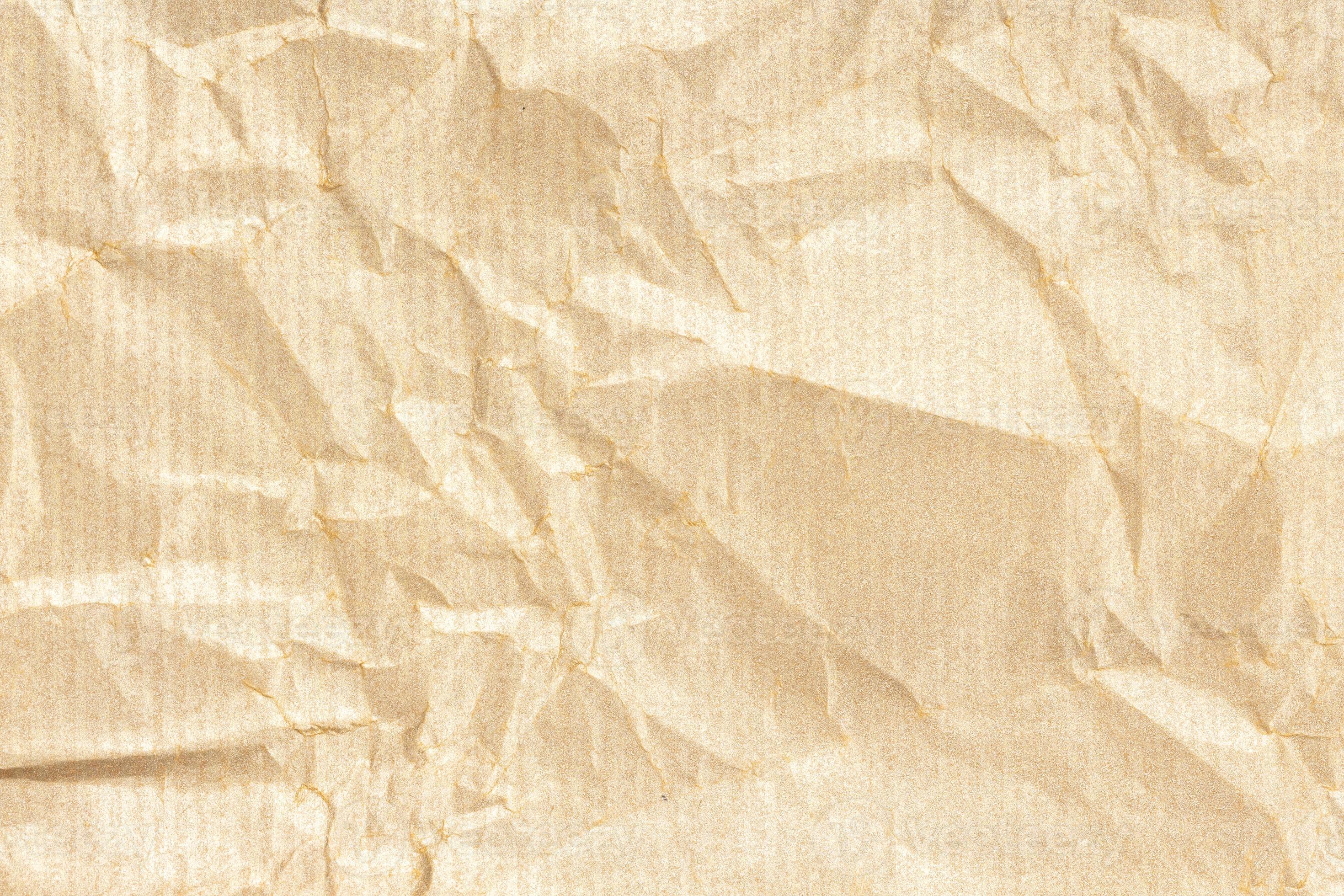 Crumpled Kraft paper texture background. Light golden brown color