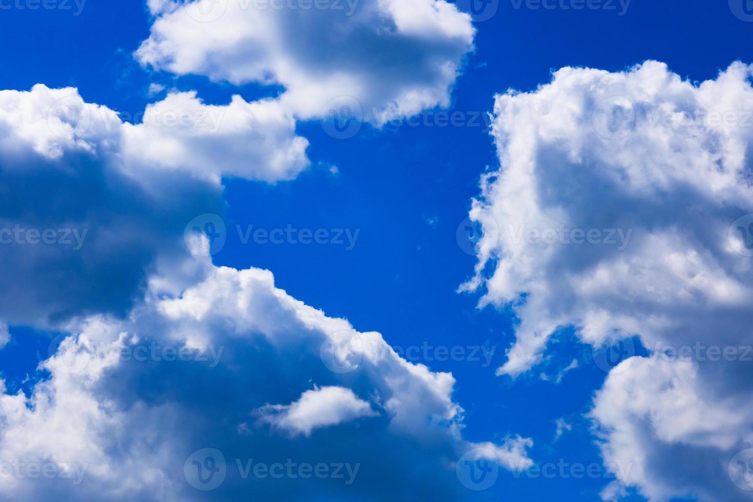 Deep blue sky with white clouds photo