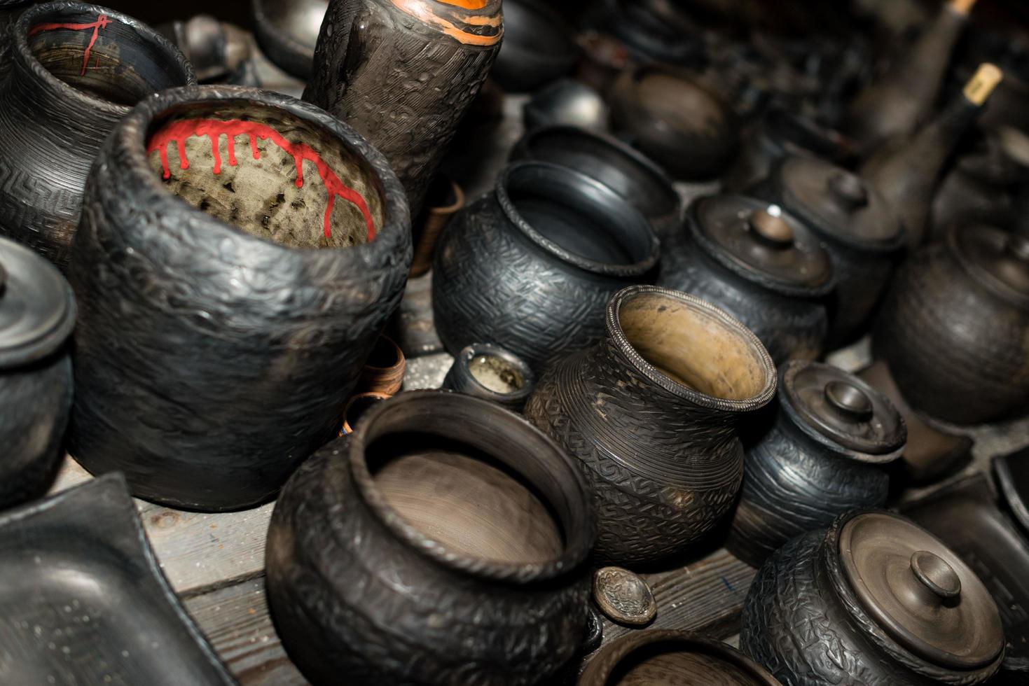 Burnt black ceramics. Burnt clay pots and plates, dishes - Image photo