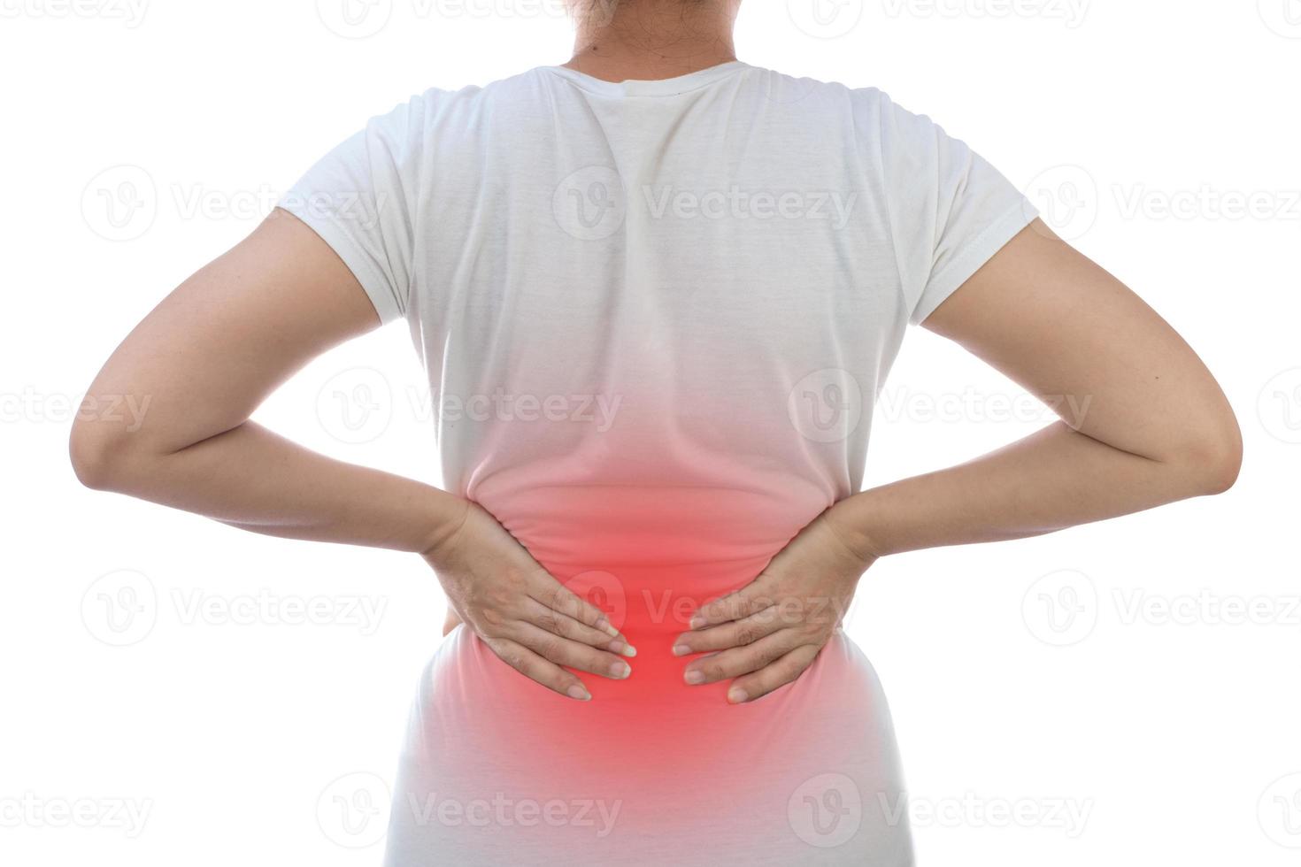 Young woman with back pain at white background photo