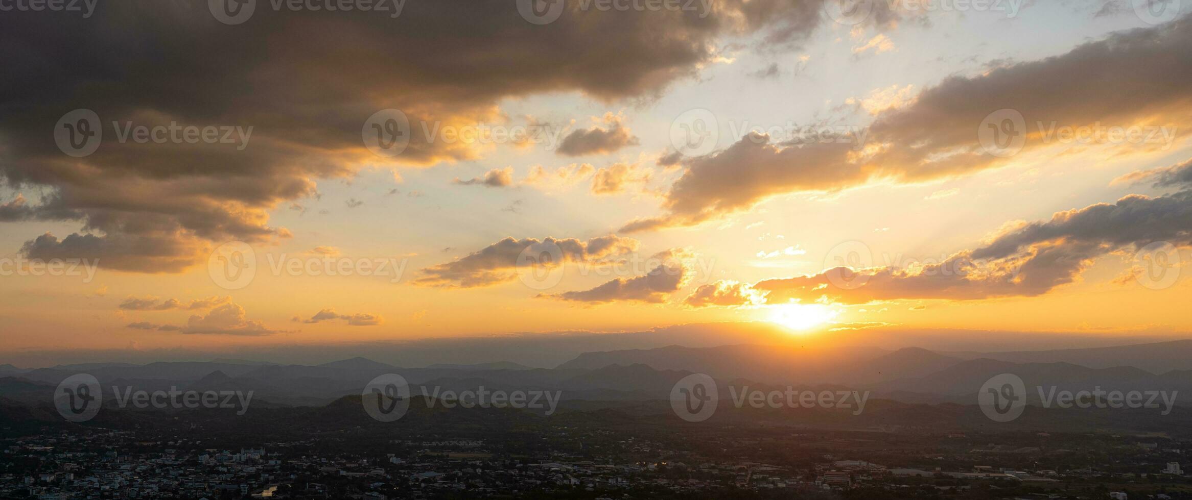 The Sun is falling behind the mountain and city view the beautiful river, Overcast sky cloud, Photo Loei  city Thailand from Phu Bo Bit mountain peak