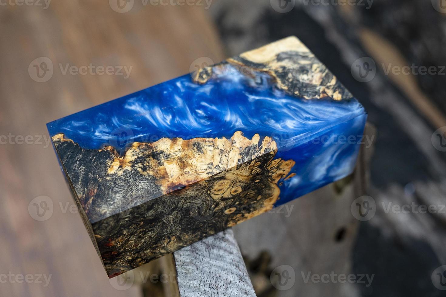 casting epoxy resin Stabilizing burl Afzelia wood blue color abstract art background for blanks photo