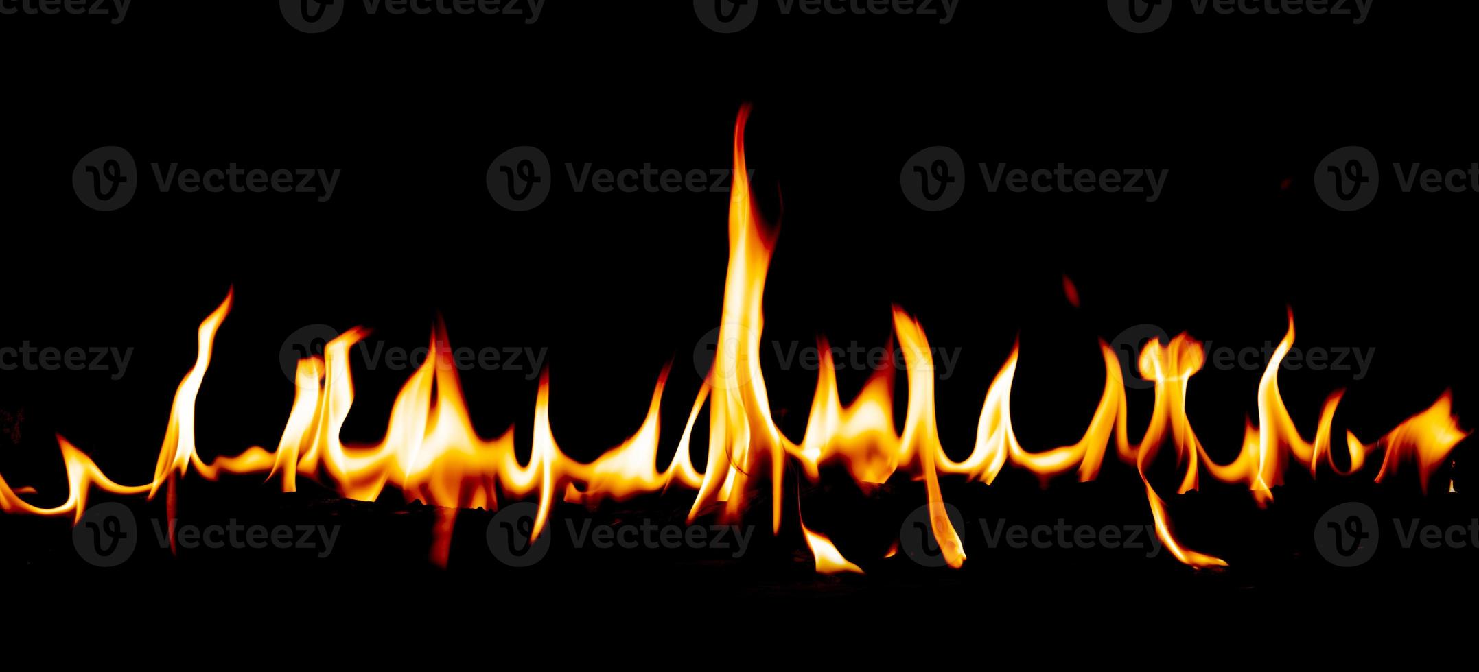 Fire flames with smoke on black background photo