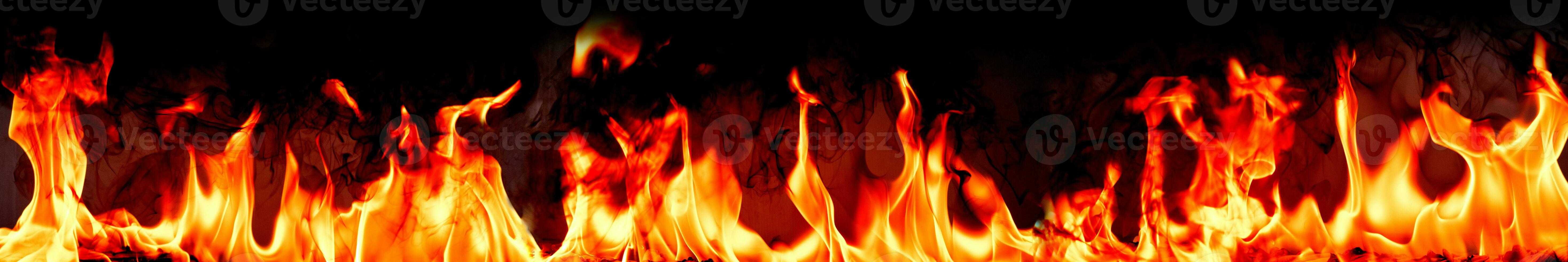 Fire flames with smoke on black background photo