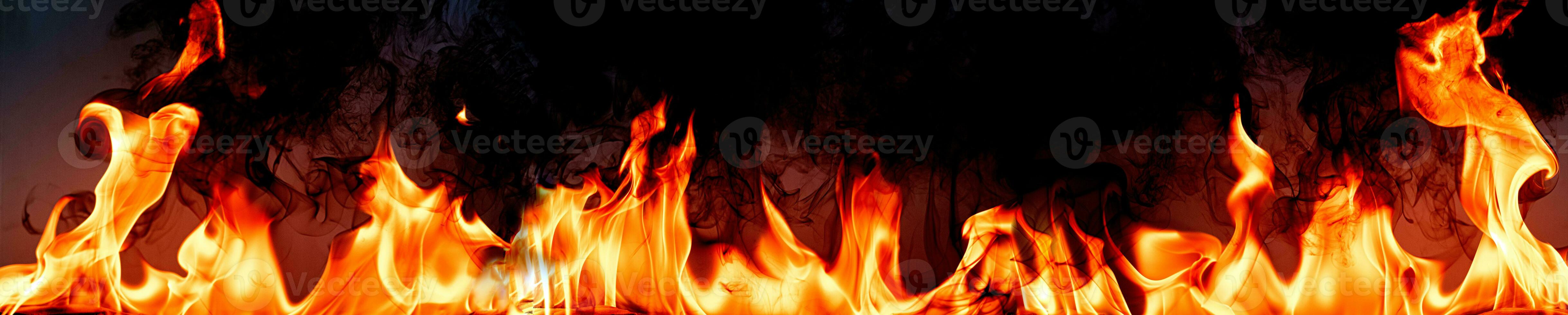 Fire flames with smoke on black background photo