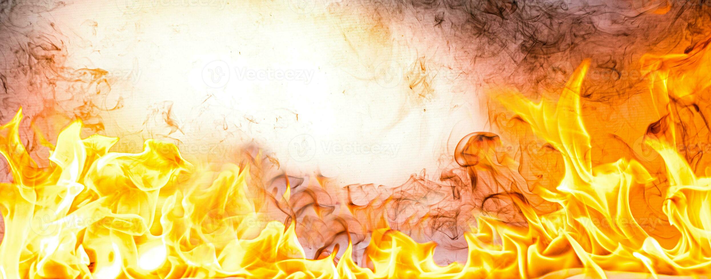 Fire flames with smoke on black background photo