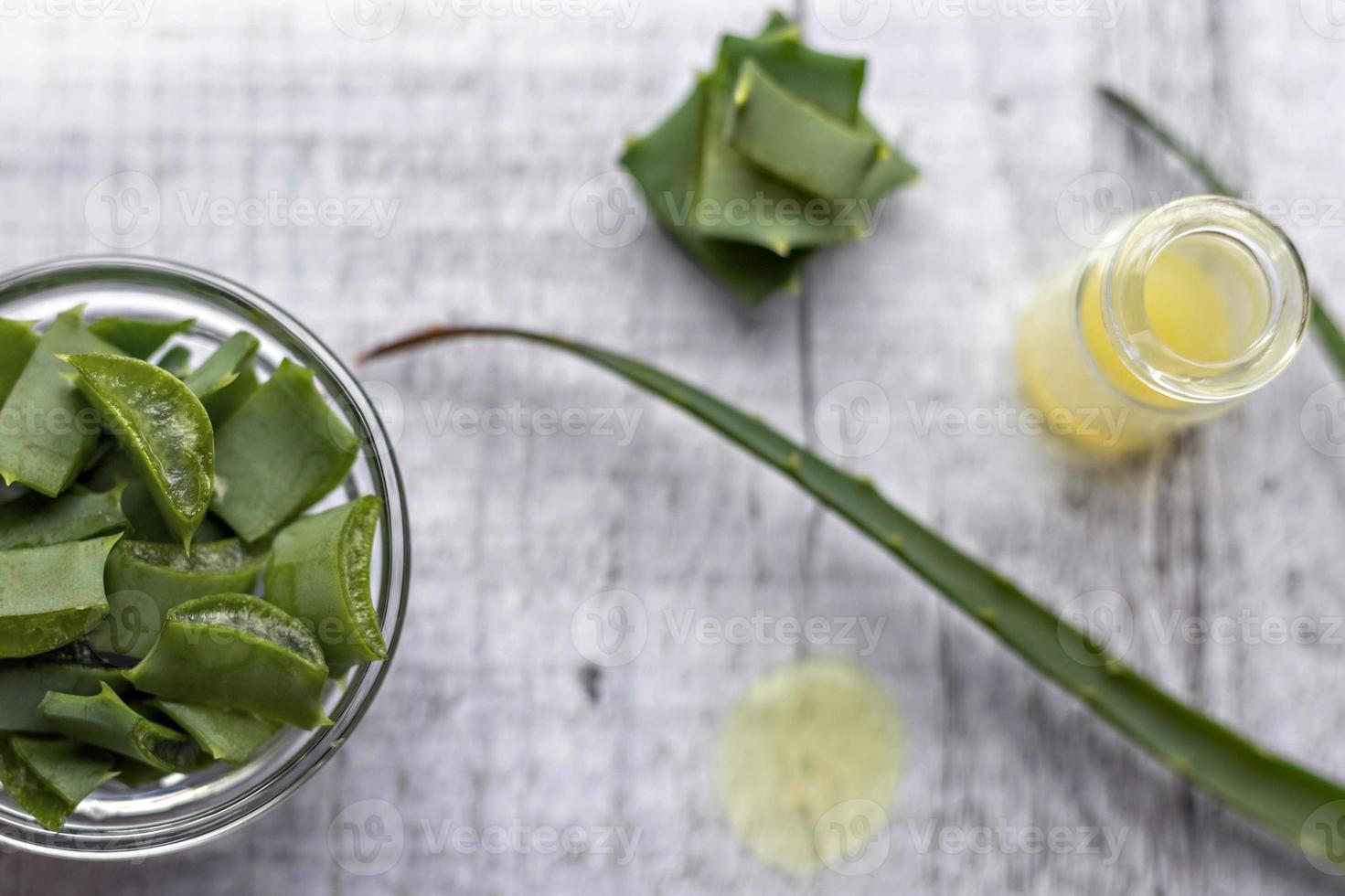 Pieces of aloe plant with gel inside in a glass bowl close-up. Alternative medicine. Collection of aloe juice, for the treatment of skin diseases. photo