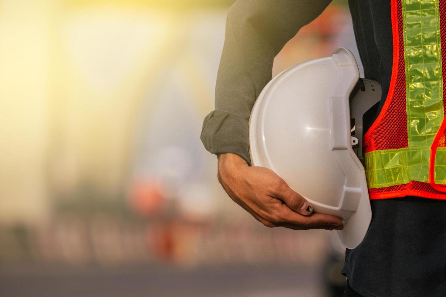 Close up engineer hold hard hat site construction background photo