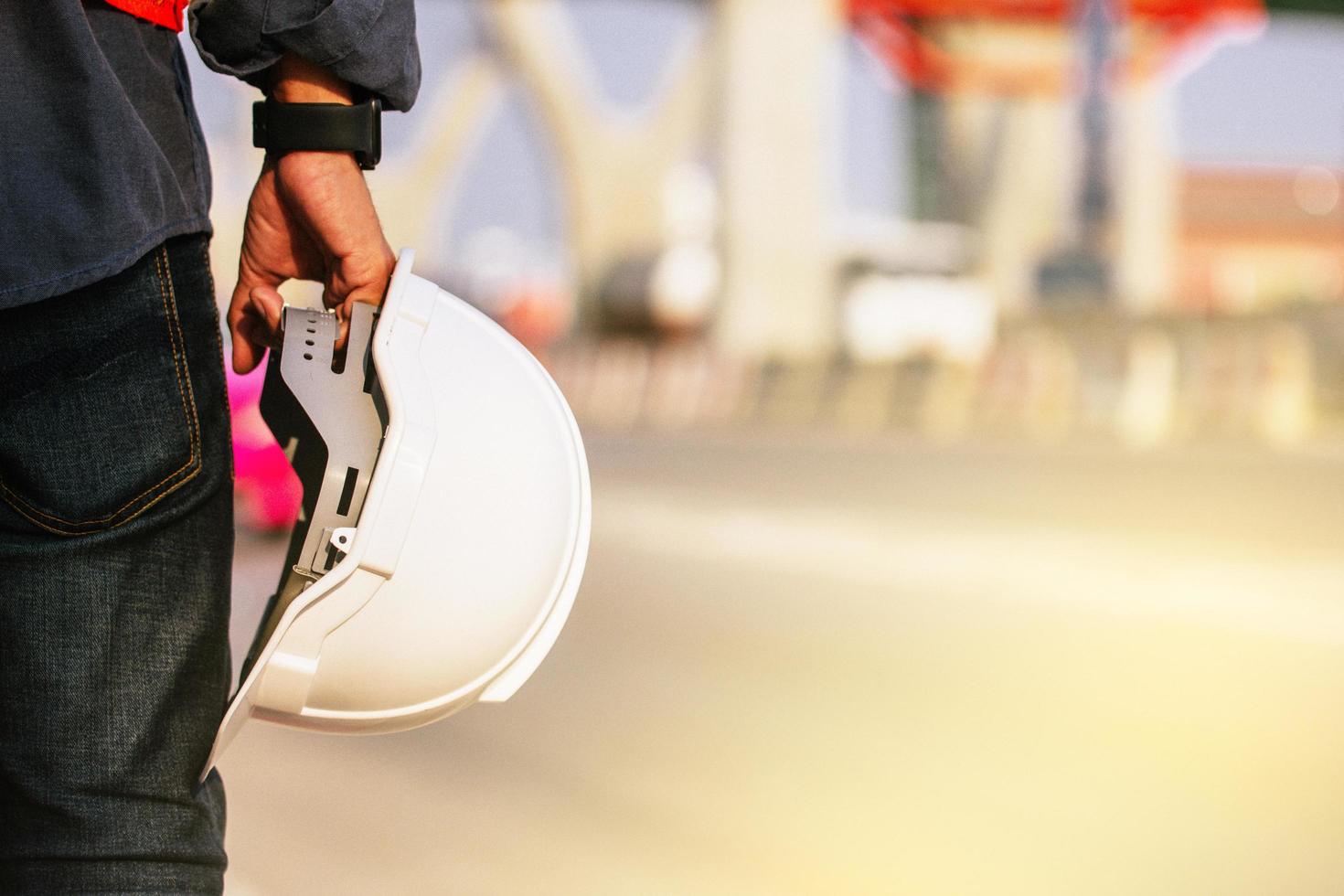 Close up engineer hold hard hat site construction background photo