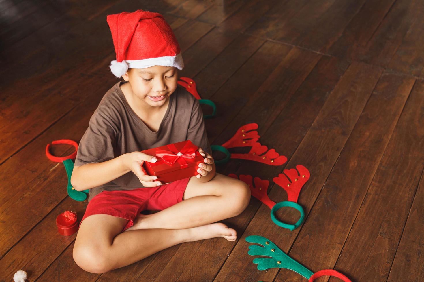 Boy with gift box on christmasday photo