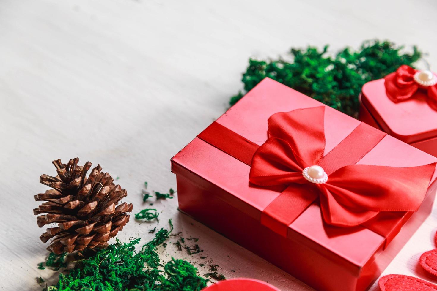 Red gift box on white wooden background for christmas day photo