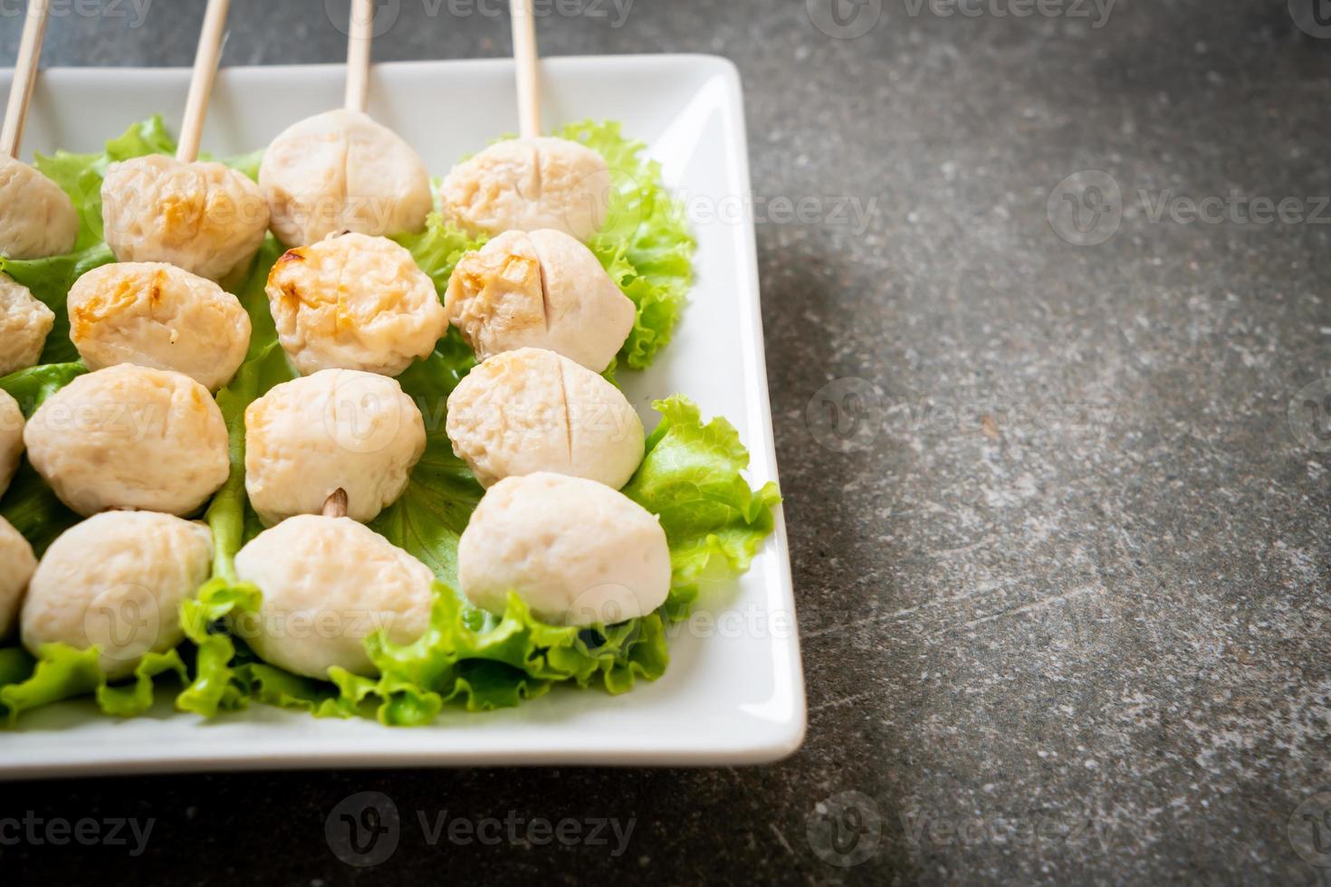 Grilled pork meatballs with sweet chili sauce on plate photo