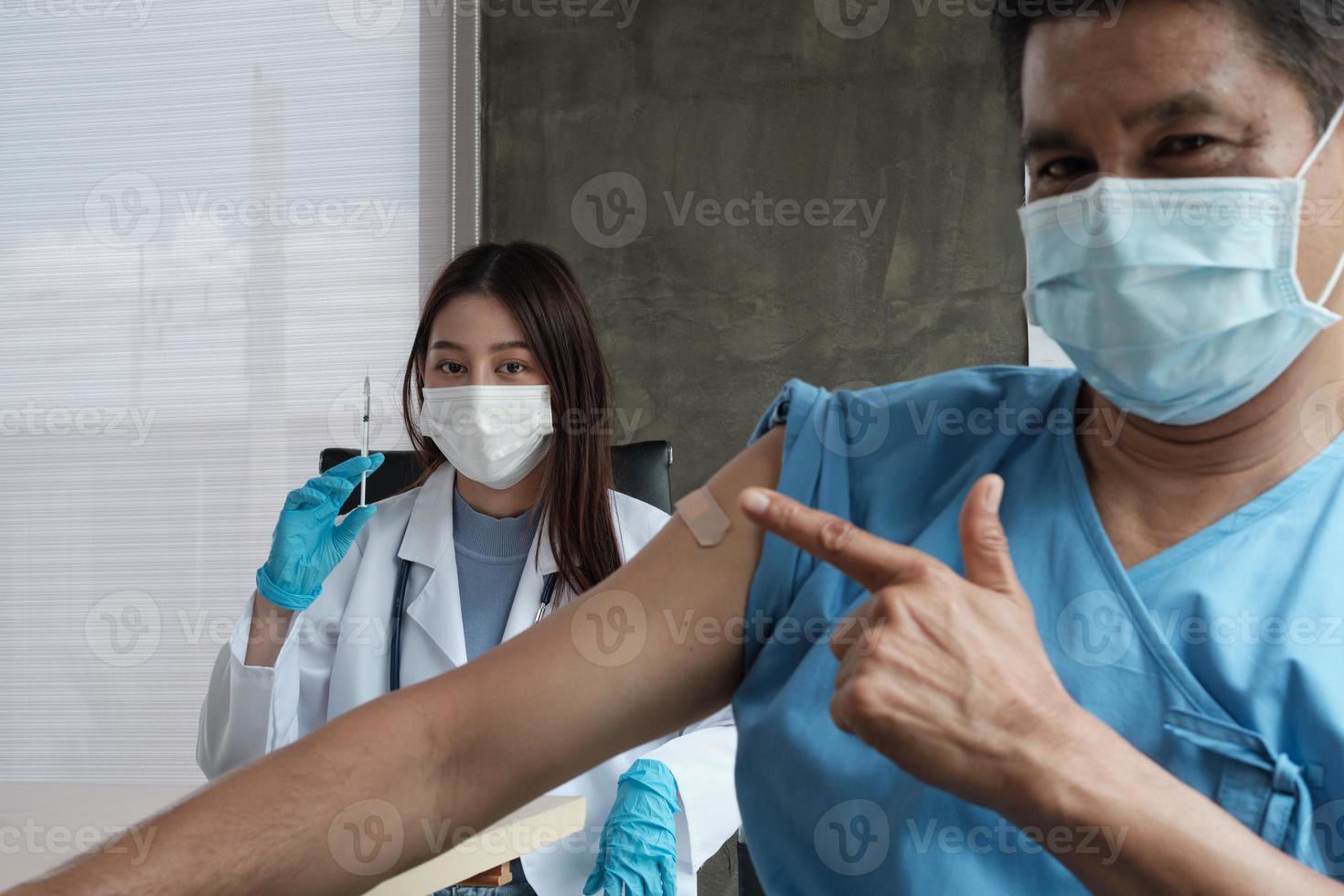 Portrait of female doctor smiling after patient vaccinating. photo