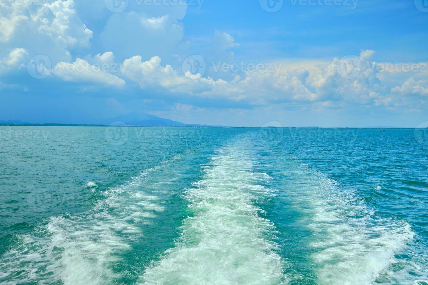 White bubbles and splashes of waves on the stern of the ferry ship. photo