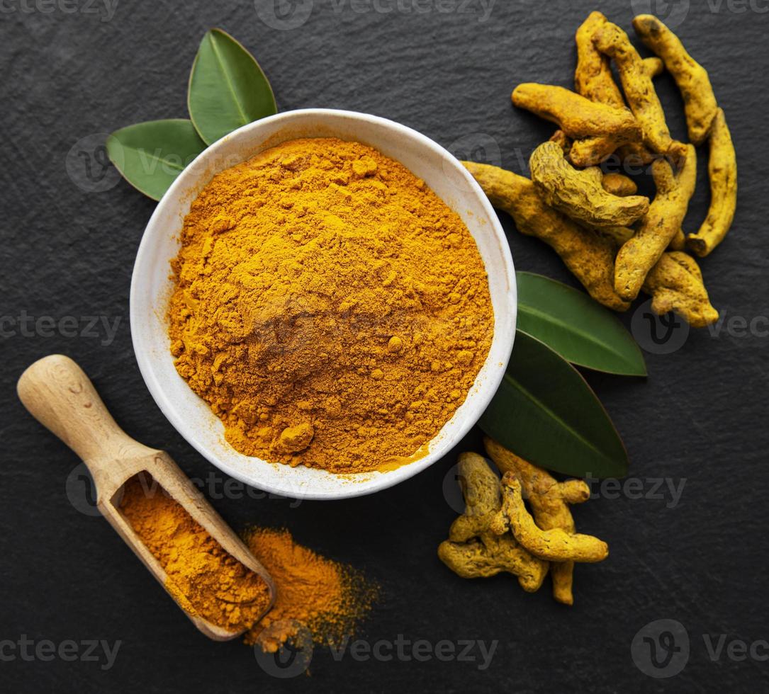 Turmeric powder and dry roots photo