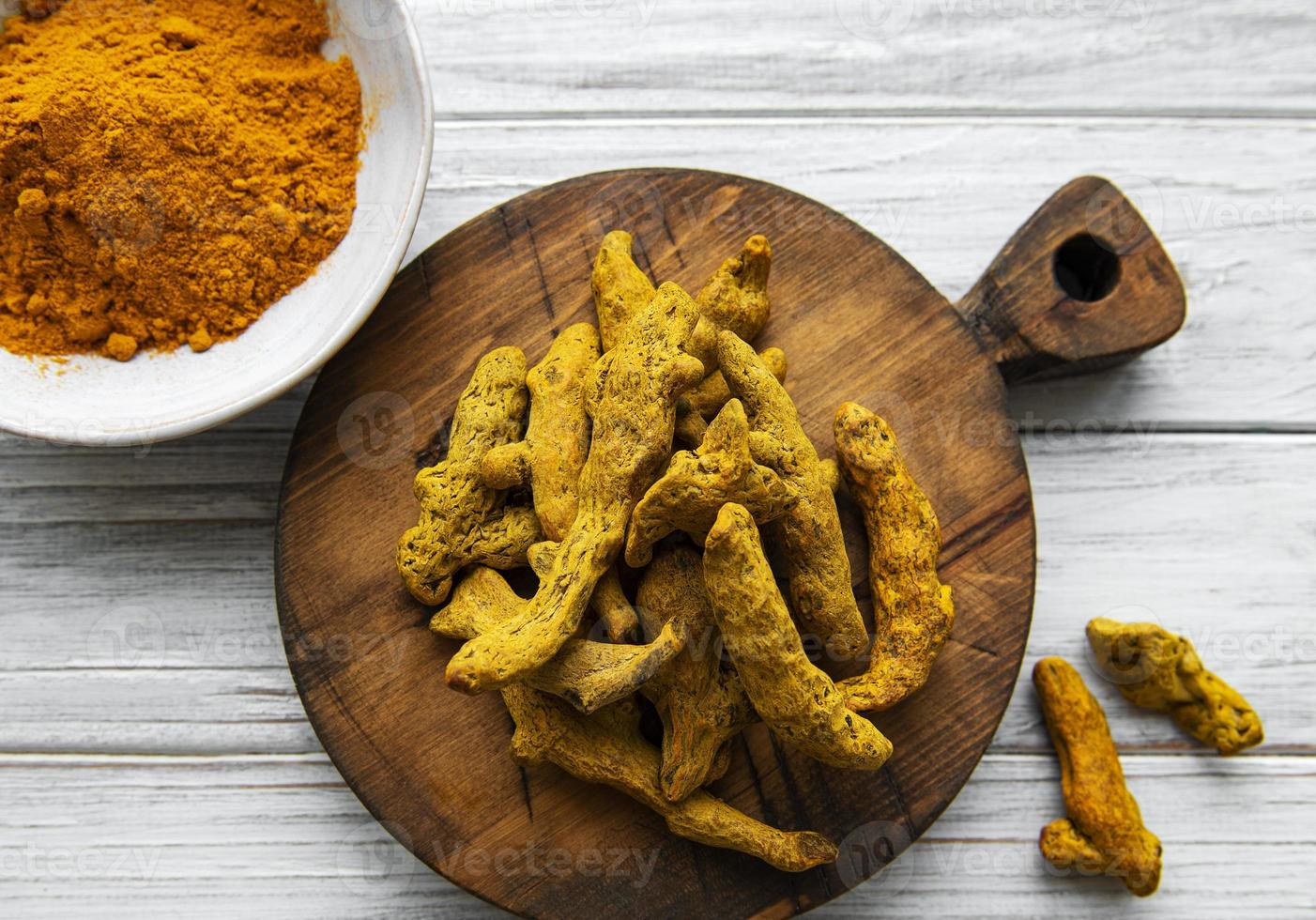 Turmeric powder and dry roots photo