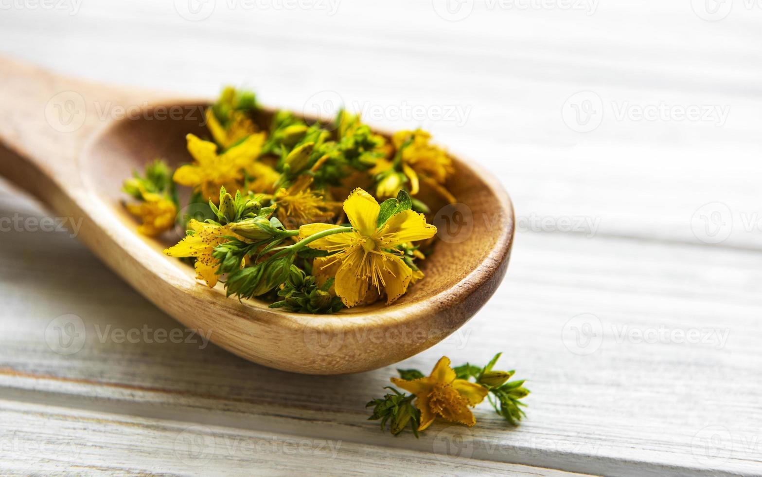 St. John's wort on the wooden spoon photo