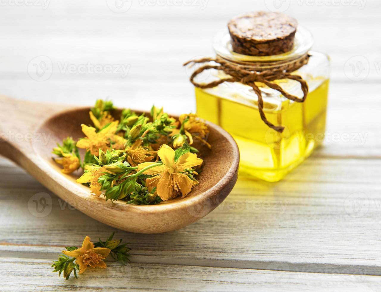 St. John's wort on the wooden spoon and natural oil photo