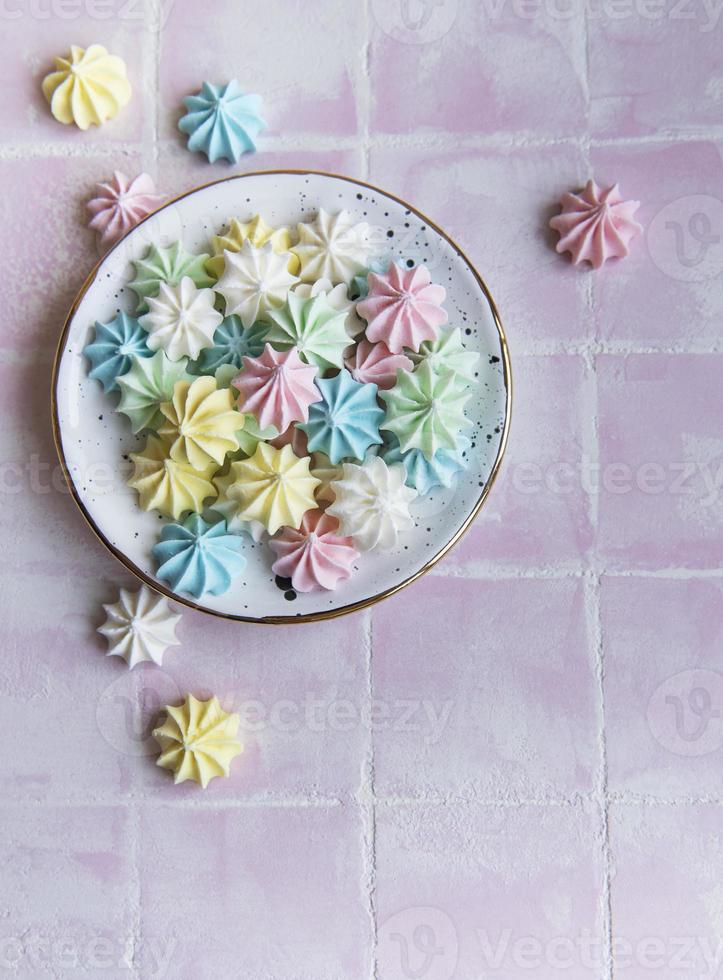 Small colorful meringues in the ceramic  plate photo